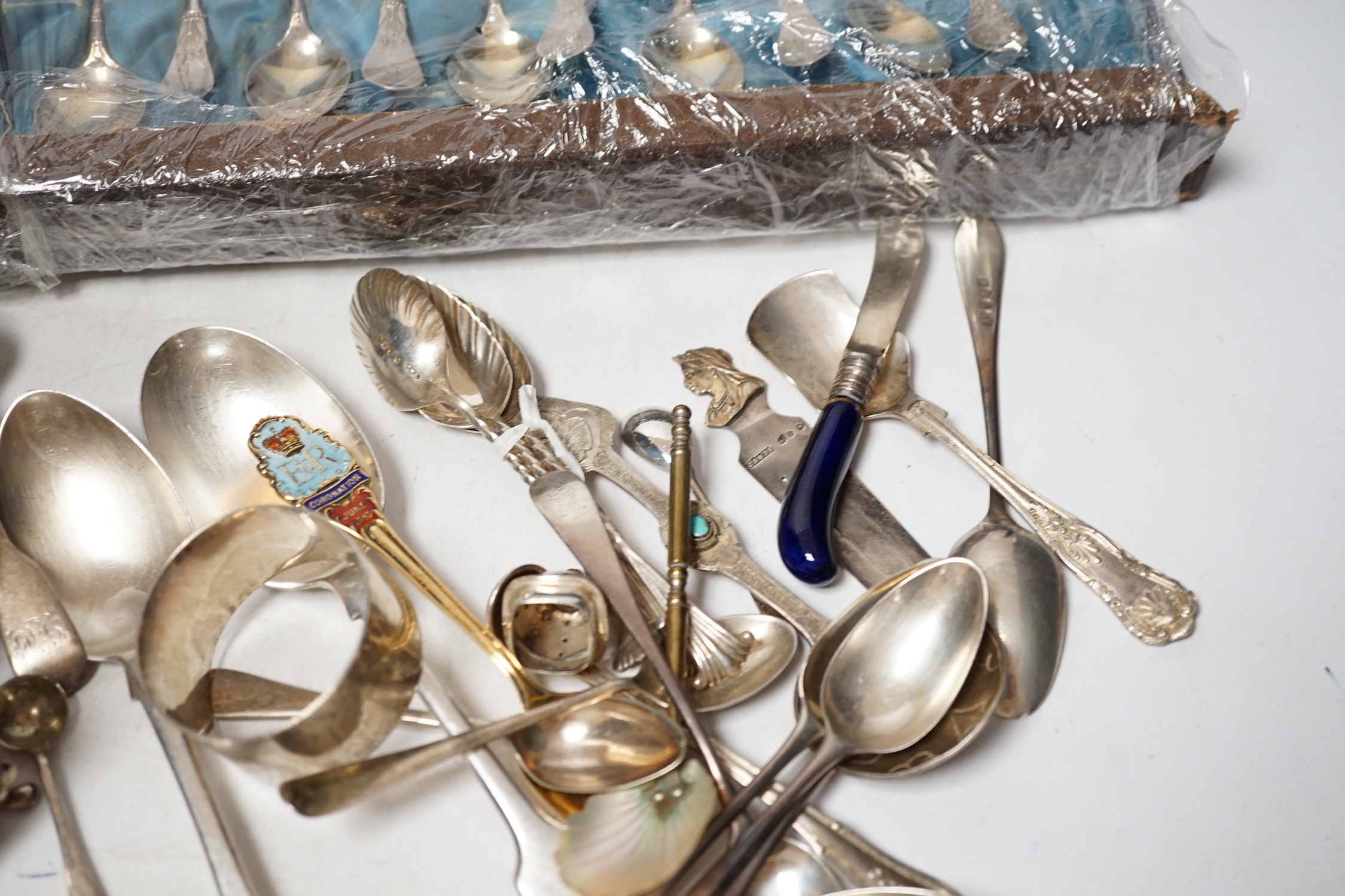 A group of assorted mainly small silver flatware, including 19th century, a small group of sterling spoons, a silver napkin ring and cased silver christening spoon and fork, etc.